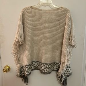 Poncho style sweater. Cream with fringe down the side. In great condition.